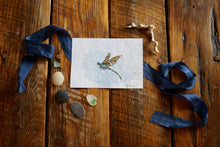 Load image into Gallery viewer, One of a kind artwork incorporating found dragonfly wing, gold leaf, watercolor paint, ink on archival cold press 5x7 watercolor paper on oak background with silk ribbon, driftwood, beach glass and pebbles
